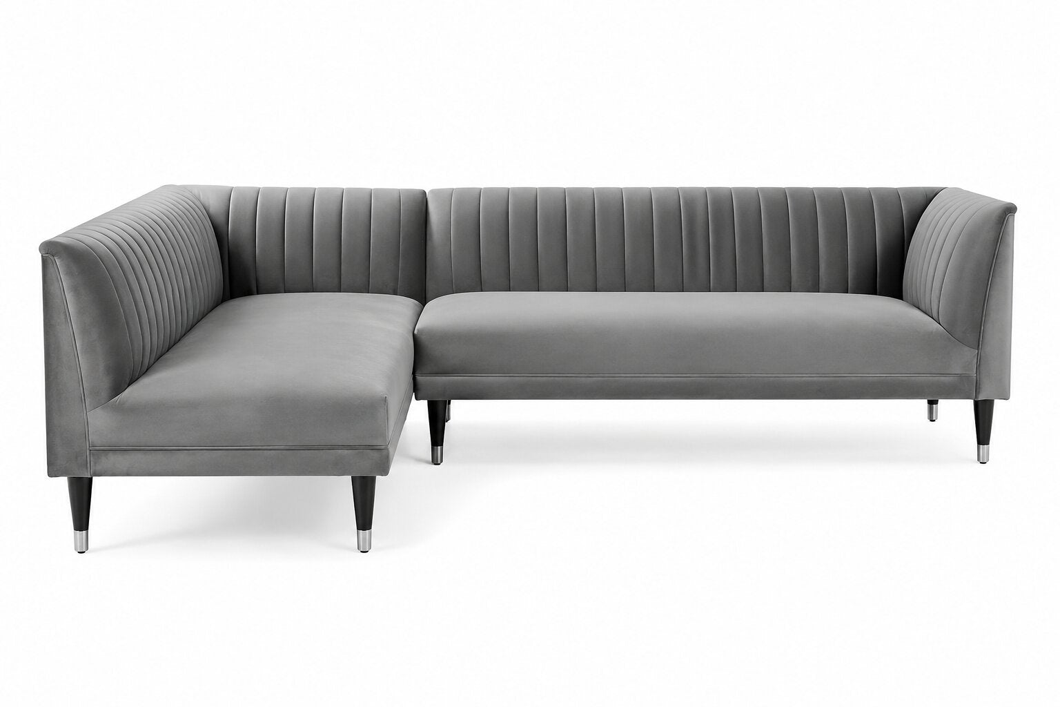 A modern gray velvet sectional sofa with vertical channel tufting on the backrest and arms, supported by slim black legs with silver tips, shown against a plain white background.