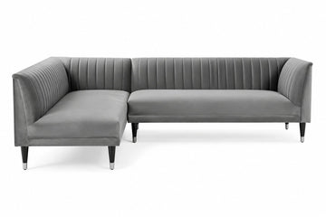 A modern gray velvet sectional sofa with vertical channel tufting on the backrest and arms, supported by slim black legs with silver tips, shown against a plain white background.