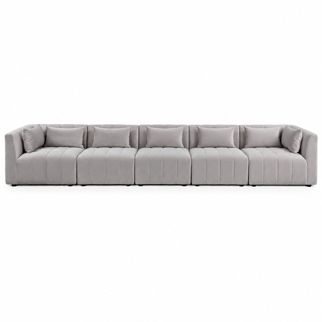 A modern modular sectional sofa upholstered in light gray fabric, featuring segmented seat cushions with vertical channel tufting and matching throw pillows, shown on a plain white background.