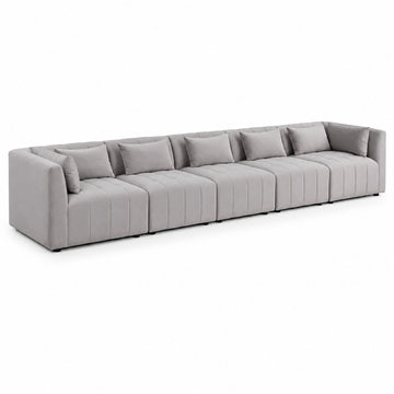 A modern modular sectional sofa upholstered in light gray fabric, featuring segmented seat cushions with vertical channel tufting and matching throw pillows, shown on a plain white background.