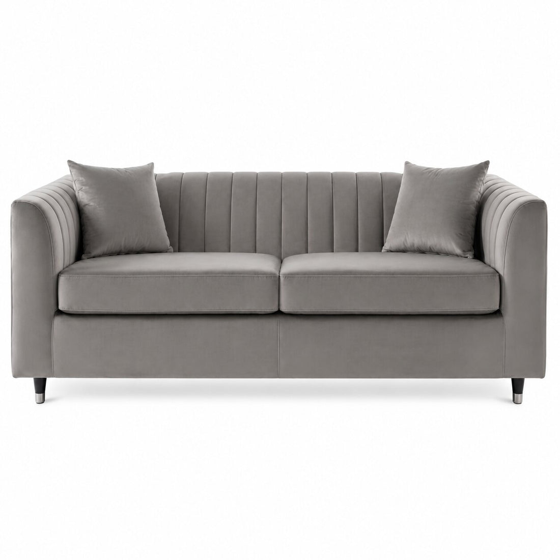 A modern gray fabric loveseat with vertical channel tufting on the backrest, two matching throw pillows, and slim dark legs, shown against a plain white background.