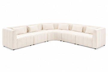 A curved modular sectional sofa upholstered in cream-colored fabric with vertical channel tufting and matching throw pillows, shown on a plain white background.