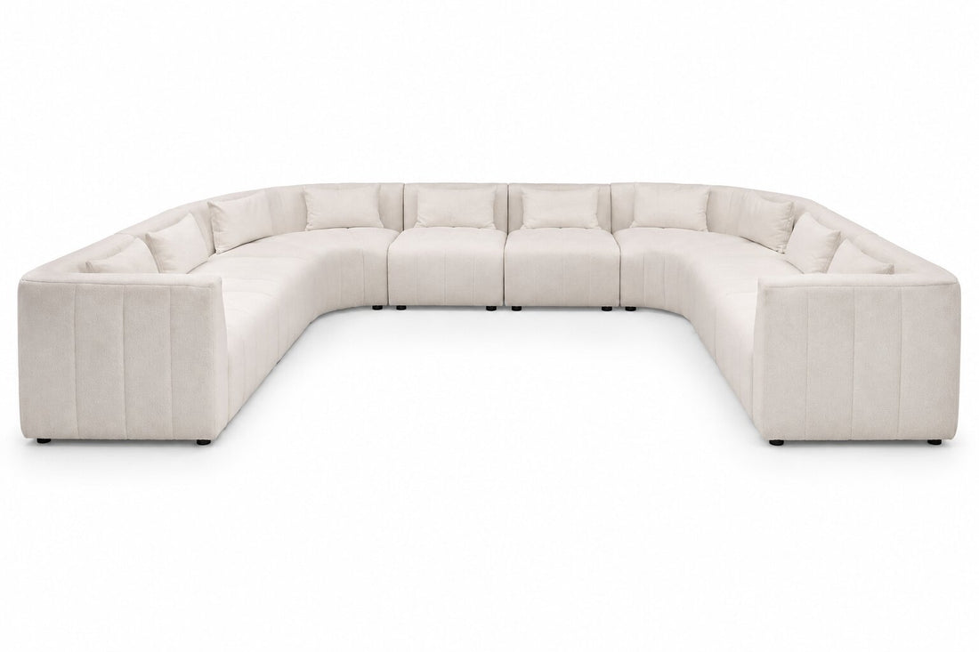 A U-shaped modular sectional sofa upholstered in a light beige textured fabric, shown from a front-facing perspective against a solid white background.