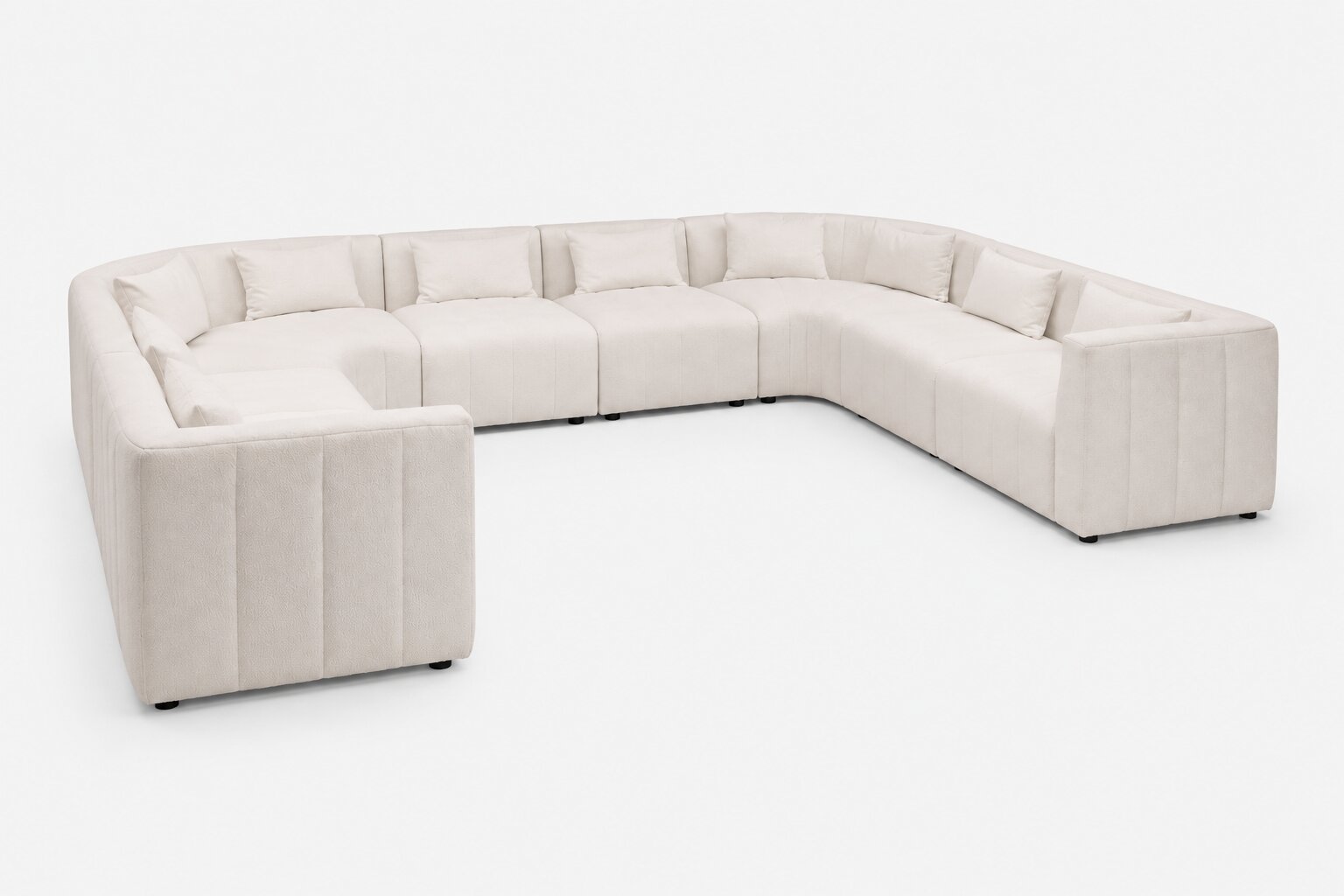 A modern U-shaped sectional sofa upholstered in a light cream or off-white fabric, shown from a three-quarters angle against a plain white background.